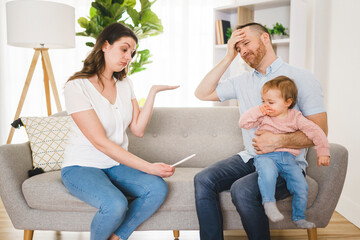 Sad Couple with pregnancy test at home interior with baby