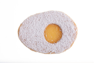 Egg shaped biscuit with sweet yellow filling and sugar powder on top.Isolated on white