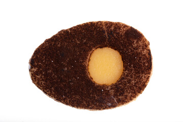Egg shaped biscuit with sweet yellow filling and chocolate sprinkles on top. isolated on white
