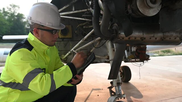 Technician fixing the engine of the airplane,Female aerospace engineering checking aircraft engines,Asian mechanic maintenance inspects plane engine