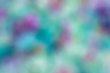 Bright colors of green, blue, purple in a defocused blur motion abstract background texture