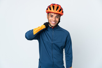 Young cyclist Brazilian man isolated on white background laughing