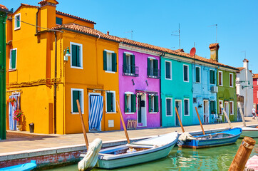 Fototapeta na wymiar Cozy colorful houses by canal in Burano Island in Venice