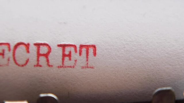 Typing "top secret" on an old typewriter