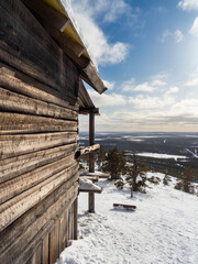 Wooden cabin and ski lifts in the mountains in Lapland, Finland