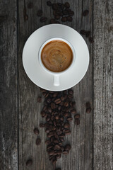 A cup of coffee and coffee beans on the table. .