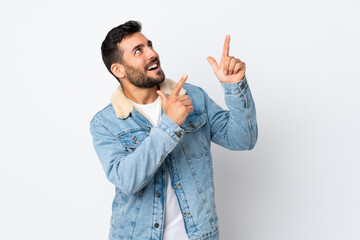 Young handsome man with beard isolated on white background pointing with the index finger a great idea