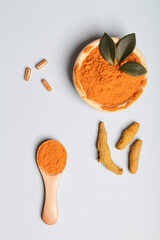  health care lifestyle concept. Curcuma Longa or turmeric powder in bowl with green leaf, wooden...