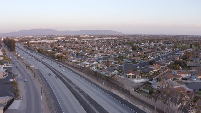 Sunset aerial view of the 101 Freeway and a residential area of Oxnard, California, USA.