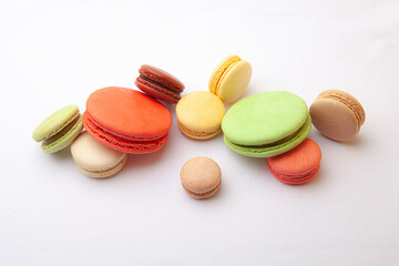 Scattered macaroons on a white tablecloth