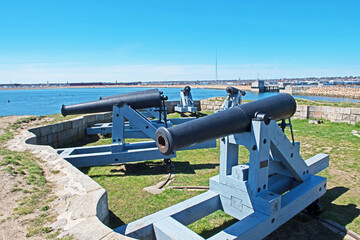 Vintage canon are mounted at Fort Phoenix guarding the entrance to the harbor in Fairhaven, Massachusetts.