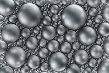 Abstract background consisting of multiple silver circles or spheres made of metal, steel or...