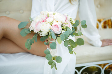 the bride holds the bouquet of flowers in her hand, the wedding floral bouquet