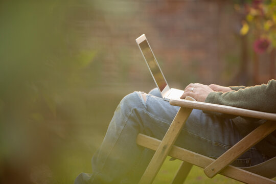 Man using laptop in garden