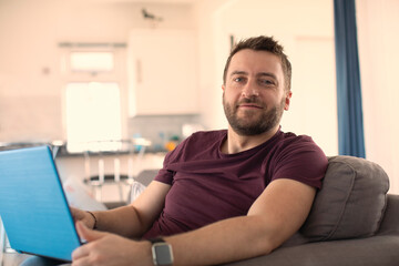 Portrait confident man working from home at laptop