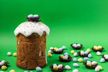 Easter Cakes or Paska and eggs composition on green background