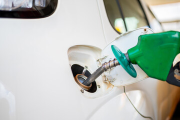 Closeup of man pumping ethanol fuel in car at gas station in Brazil.