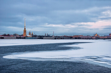 Winter evening view of the Peter and Paul Fortress from the Palace Bridge in St. Petersburg.