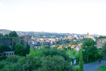 Scenic view panorama landscape of old town Tbilisi, Georgia in summer, park in mountains at evening at sunset