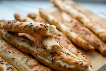 Homemade baked grissini sticks sprinkled with caraway seeds