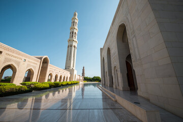 Exterior view of Sultan Qaboos Mosque, Muscat, Oman. A panoramic shot of magnificent mosque and minaret.