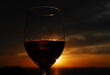 FOOD- Greece- Close Up of a Red Wine Toast at Sunset