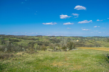 Fototapeta premium Green valleys and hills, blue sky. Arrival of Spring