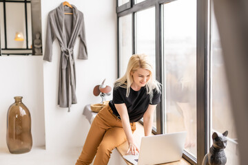 young beautiful woman using a laptop computer at home