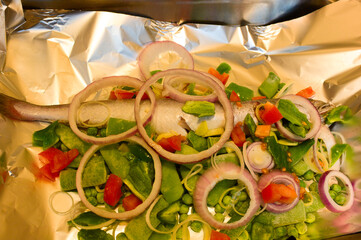 Fish garnished with vegetables to be baked a la papillote