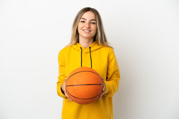 Young woman over isolated white background playing basketball