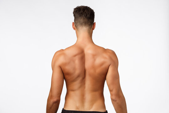 Attractive Sportsman Rear View, Masculine Strong Back, Athlete Posing From Behind, Showing Perfect Body, Muscles And Abs, Standing White Background, Promote Workout, Gym Membership And Fitness