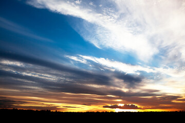 Sunset sky, bright setting sun.