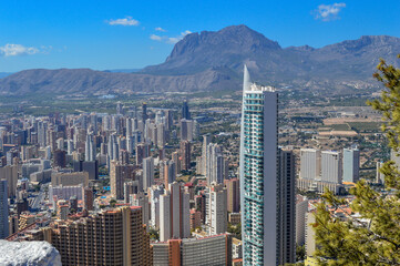 Obraz premium Benidorm. High-rise building on the background of the city and mountains