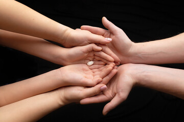 bean on hands of mother and father and child, family