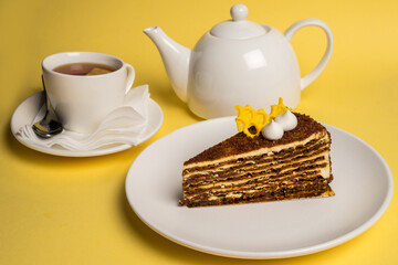 Delicious breakfast with the cake and black tea on yelow background. Top view. Copy space.
