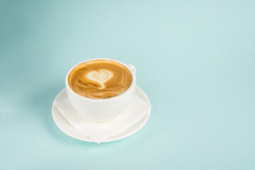 Cup of coffee with heart on the blue background