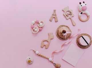 Baby girl pink card. Newborn background. Baby shower invitation. Creative layout made of fondant baby accessories, minimal concept. Flat lay, text space.