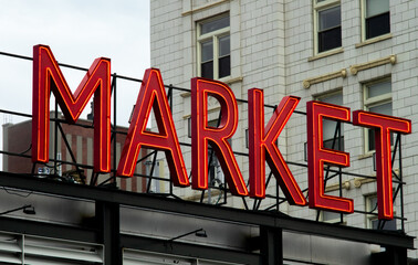 Neon Market sign in downtown city