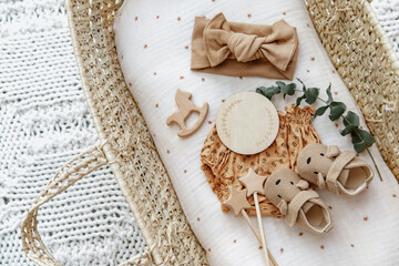 Flat lay composition with cute baby items in basket. The concept of awaiting baby, pregnancy
