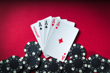 Poker game with five of kind combination. Chips and cards on the red table