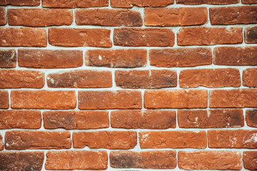 The wall is made of old red brick. Template design. Brown brick wall. Texture and pattern.
