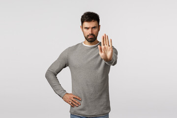 Serious and assertive bearded man trying prevent accident happen, restrict or warn, pull back,...