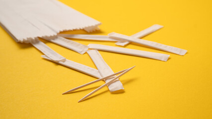 Scattered individual paper wrapped toothpicks. Packed wooden toothpicks. Individually wrapped mint wooden toothpicks