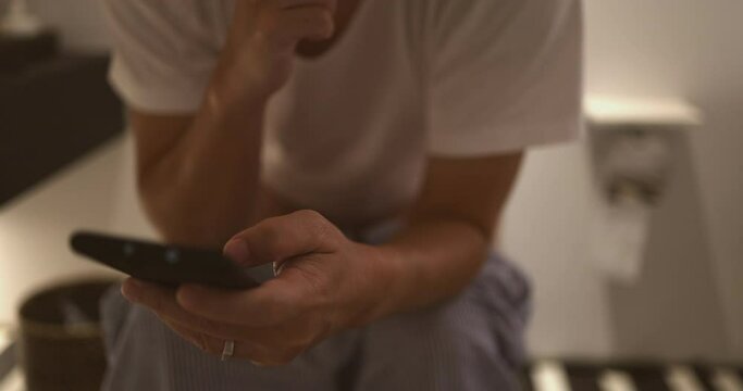4K Close up slow motion man use mobile phone during sitting on toilet. Concept of mobile phone and internet addict.