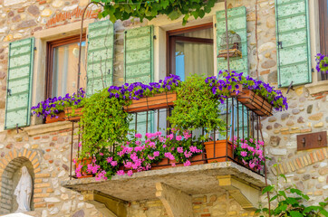 Beautiful window decorated with flowers in Italy.