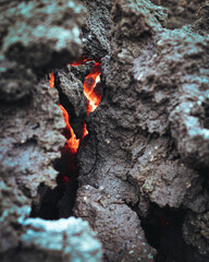 Red hot lava hiding in the lava rocks in Iceland. 