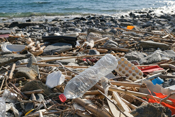 Obraz premium Dump of plastic garbage pollution on contaminated sea coast ecosystem,environmental waste 