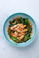 grilled squid with spinach top view on white concretr background