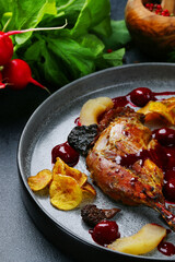 roasted duck legs baked in oven with fruit and potatoe with green and ingredients