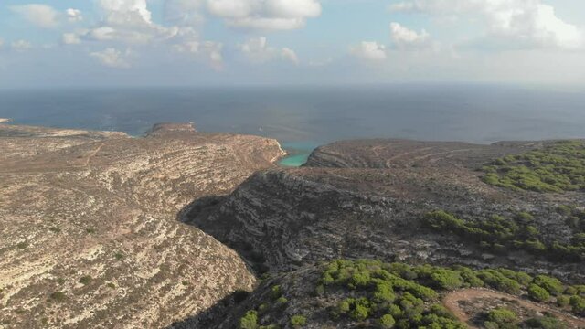 Aerial shot Lampedusa Island (Drone 4k), seagulls, isola dei conigli at sunset - concept of paradise on earth, happiness and travel to beautiful places